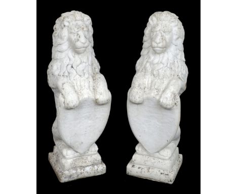 * Lions. An impressive pair of 20th-century reconstituted stone lions, modelled upright holding a shield and formerly garden 