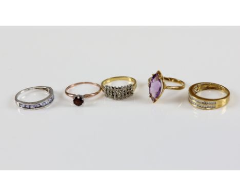 Five gem set rings, channel set diamond ring, another set with tanzanite, amethyst marquise ring, others garnet and diamond p