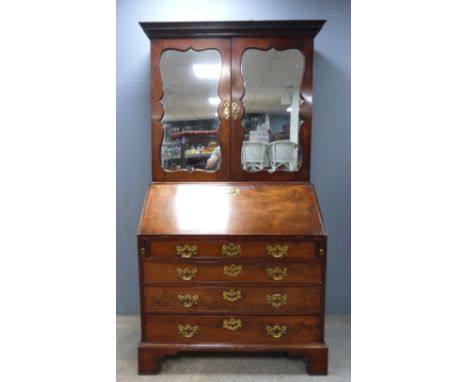 George III mahogany bureau bookcase, the top with two mirrored doors, the fall front with fitted interior all above four draw