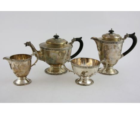 George V silver four piece tea service, comprising teapot, hot water jug, two handled sugar bowl, and milk jug,  decorated wi