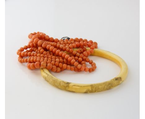 Graduated coral bead necklace, round beads measuring 4 to 6mm in diameter, strung on cord, measuring approximately 124cm in l