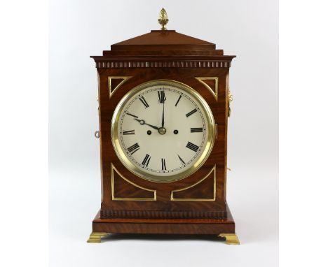 Regency style mahogany bracket clock with double fussee movement, brass inlay and flame finial and lions mask ring handles th