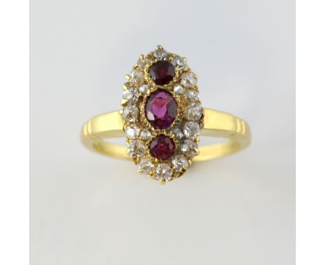 Early 20th C ruby and diamond ring, marquise form, centre with three rubies, surrounded by old cut diamonds, mounted in gold 