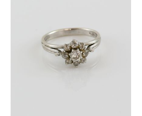 Vintage diamond cluster ring, central round brilliant cut diamond, surrounded by eight old cut diamonds, estimated total diam