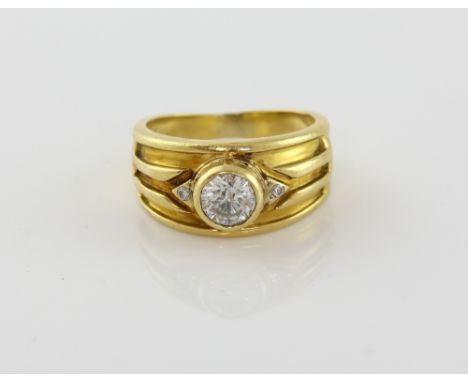 Vintage diamond ring set with central stone estimated at 0.60 carat, with two small diamonds set into the band, testing as 18