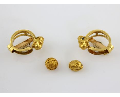A pair of Etruscan style tiger head clip on earrings, mounted in yellow metal stamped 18 ct, measuring approximately 3.7 x 3 