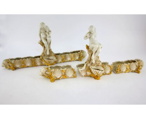 Pair of Royal Worcester centre pieces with finials of a man and woman perched on a log, mark to base  20 x 44 cm .   both hea