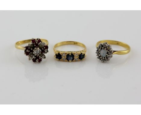 Three gold rings, ruby and diamond cluster ring, size O, with a sapphire and diamond ring with scrolled under gallery, size N