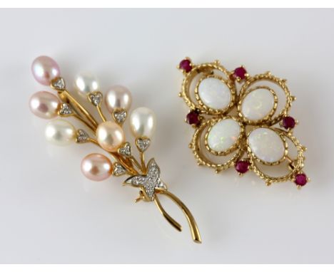 Opal and ruby quatrefoil brooch, four oval cabochon stones, centrally set  and six round cut rubies, measuring 4 x 2.5cm, and