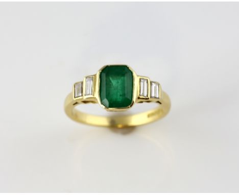 Emerald and diamond ring, step cut emerald, estimated weight 1.21 carats, set with four baguette cut diamonds 0.16 carats, mo