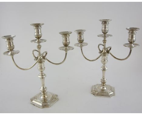 Pair of George V silver three light candelabra, with knopped stems on shaped square bases, by Goldsmiths & Silversmiths Co. L