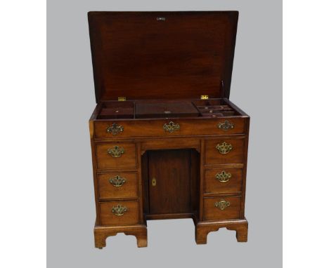 19th Century mahogany kneehole desk with hinged top revealing a fitted interior and six drawers, with a cupboard in the kneeh