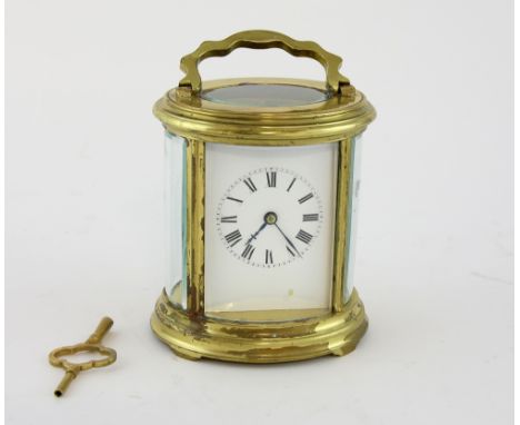 Oval French brass carriage clock, striking on a gong. 16cm