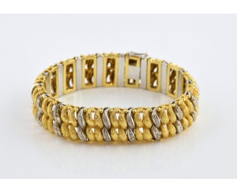 Vintage gold bracelet of textured and diamond set scroll links, measuring 18.5cm in length, with hidden catch and figure of e