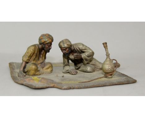 Bergman style early 20th century cold painted bronze Arabs playing dice, seated on a rug,  Austrian School 13cm wide.   
