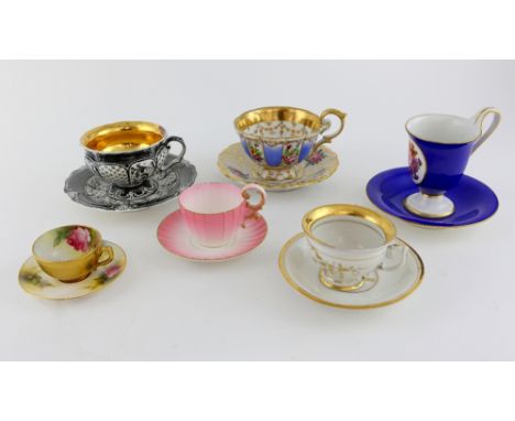 A group of six cups and saucers, to include two Worcester cups and saucers, a silver and gilt KPM cup and saucer, and two fur