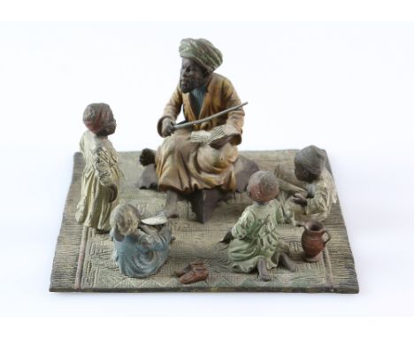 Bergman style early 20th century cold painted bronze figure group,  the teacher depicting an Arab seated on a rug teaching hi