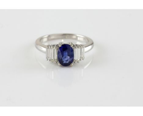 Sapphire and diamond ring, central oval cut sapphire, estimated weight 1.55 carat, set with four baguette cut diamonds, estim