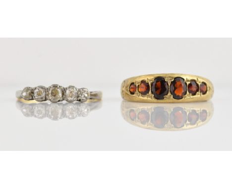 Edwardian diamond set ring, with five stones in claw setting, stamped 18 ct, and a later garnet set ring, 9 ct  .   Diamond f