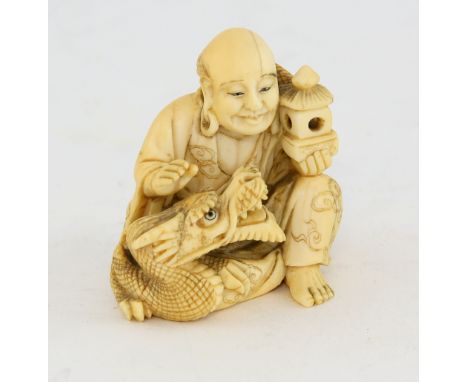 19th Century Japanese carved netsuke of a man with a dragon, signed  4 cm .   