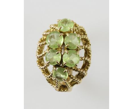 Vintage peridot spray brooch, round and oval cut peridot, looped wirework, measuring approximately 5.2 x 4cm, with pin and ro