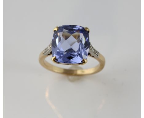 Synthetic blue spinel ring, estimated weight 8.38 carats, with rose cut diamonds shoulders, mounted in yellow metal testing a