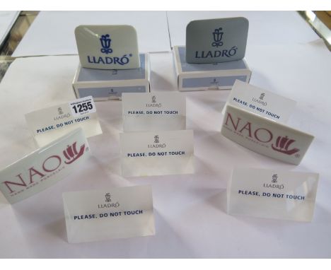 Two boxed Lladro china trade table top signs, two Nao signs and six Lladro perspex signs 