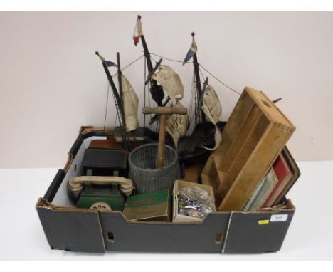 A box containing a wooden galleon, cameras, miniature cuckoo clock, music books, a miniature poss stick and tub, vintage knif