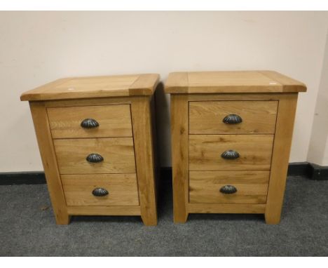 A pair of good quality light oak three drawer chests, width 53cm (2)