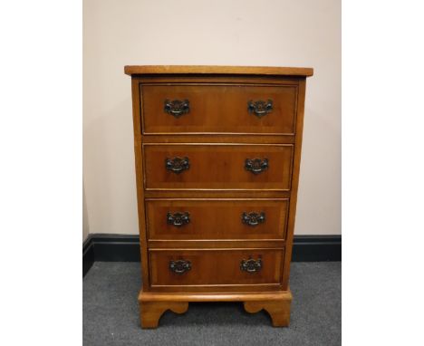 A yew wood four drawer chest on bracket feet 
