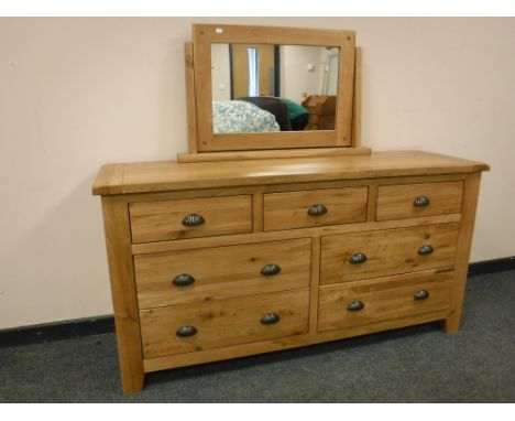 A good quality light oak seven drawer chest with dressing mirror, width 150cm 