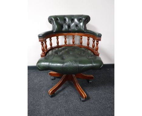 A green button leather captain's desk chair 