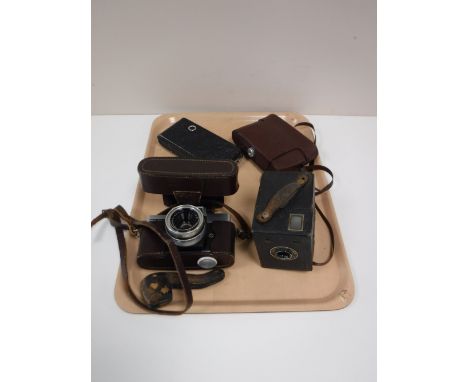 A tray containing four vintage cameras, including a Brownie, Agfa, together with a cased pipe 