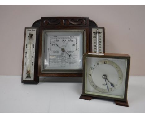A carved oak barometer by Walker of Sunderland, together with a cased Elliot mantel clock 