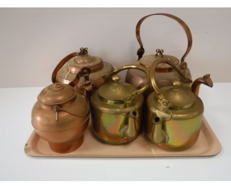 A tray of two copper kettles, two brass kettles and a brass lidded caddy 