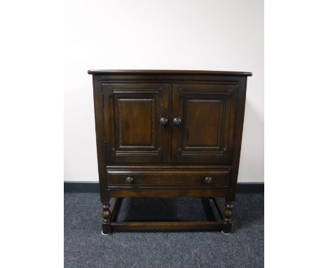 An Ercol double door cabinet fitted with a drawer, width 79cm 