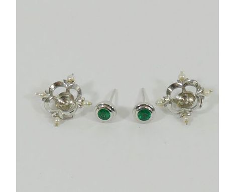 A pair of 18 carat white gold emerald and seed pearl earrings by Cassandra Goad, the round mixed cut emeralds set at studs in