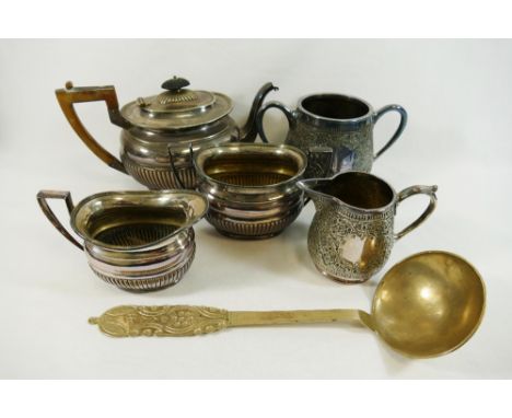 A large brass ladle with hammered design, 33cm long, a silver plated three piece teaset, with half reeded body and a large si