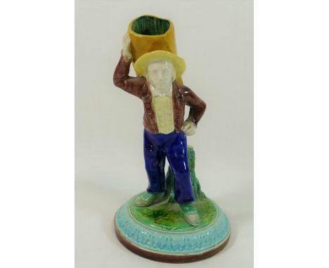A Royal Worcester porcelain figural spill vase of a farm hand carrying a sack on his back with impressed mark to base, 14cm h