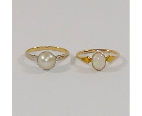 A pearl single stone ring, the cultured pearl in white setting to plain white shoulders and a yellow shank, finger size K, un