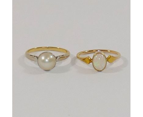 A pearl single stone ring, the cultured pearl in white setting to plain white shoulders and a yellow shank, finger size K, un