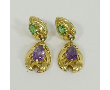 A pair of yellow metal amethyst and green tourmaline drop earrings, the oval mixed cut tourmaline claw set above a pear-shape