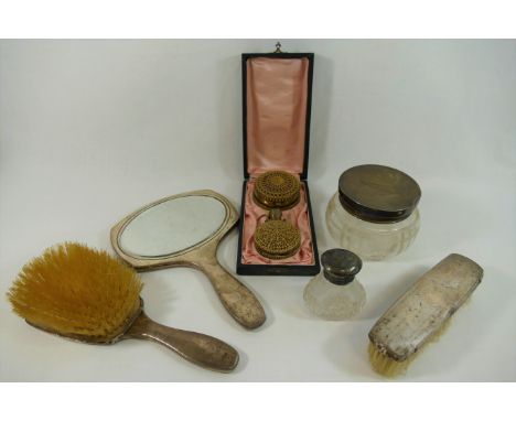 Three silver backed dressing table items comprised of a two brushes and a hand mirror, a silver topped cut glass dressing tab