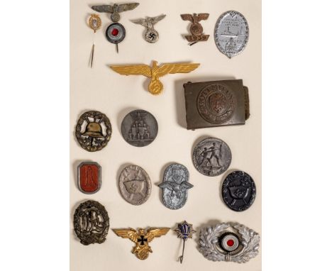 A group of German military badges and cap badges:, including a wound badge, a Minesweeper stick pin, a DRL badge, a belt buck