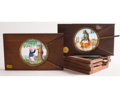 Four lithograph magic lantern glass slipping slides:, together with two  brass lever slides, one of a nanny with crying baby,