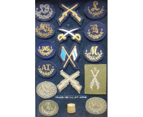 A collection of Guards trade and skill-at-arms cloth badges: including, Signaller, Gun Layer, Sub Machine Gun, Light Machine 