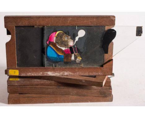 A 19th century hand painted magic lantern double slipping slide of an anthropomorphic monkey smoking a pipe with moving eyes: