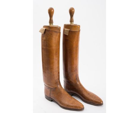 A pair of  brown leather riding boots and trees by Peal &amp; Co, London:, the boots stamped to interior with maker's mark an