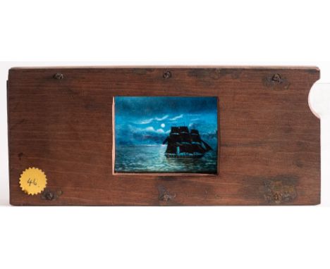 A 19th century hand painted magic lantern slipping slide of a sailing ship on a moonlit sea:, unsigned, 