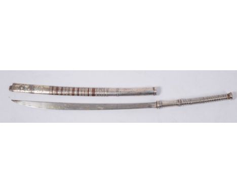 A late 19th century silver mounted Burmese dha:, the shaped curved blade over a rounded hilt with beaded banding and wirework